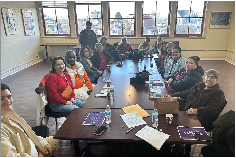 People gathered around a table at Cafecito con Charla.